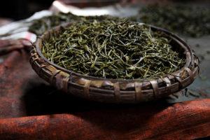 A tray of exhumed fermented Burmese laphet. Myanmar differs from all other tea producing nations because the majority of tea produced here is eaten rather than drunk. Fermented in large box's or holes in the ground holding several tonnes and left for anywhere between 3 to 6 months the final product is mixed with onions, chillis, garlic for example producing a Burmese style salad or added to other dishes for flavour creating an industry that is worth millions of dollars every year. Termed 'laphet' in Burmese, this pickled tea is not only unique to the country but is also one of the most important national delicacy's. The epicentre of Myanmar's tea is a small ridge-topped town called Namshan in Shan State and is inhabited by the Palaung ethnic minority. Believed to be the place where tea seeds were first given to the local people by a Burmese king who had brought them from abroad around 800 years ago. The best pickled tea in the country is made here and almost everyone in the town is invoilved in the industry that every year sends thousands of tonnes of pickled tea to Mandalay and Yangon.